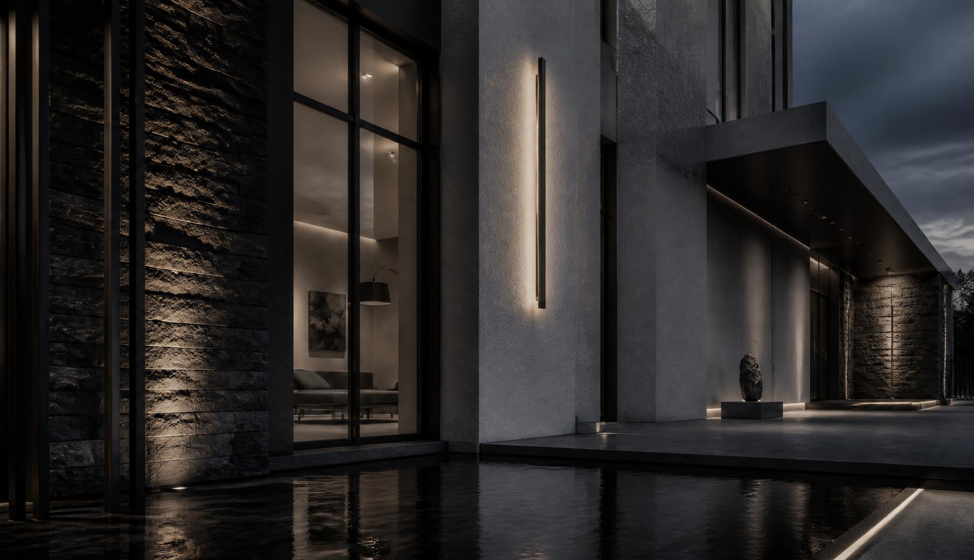 Charcoal stone and grey plaster villa facade at blue hour with warm bronze lighting and a still reflecting water channel